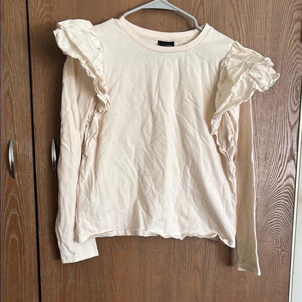 Ruffle shoulder cream blouse